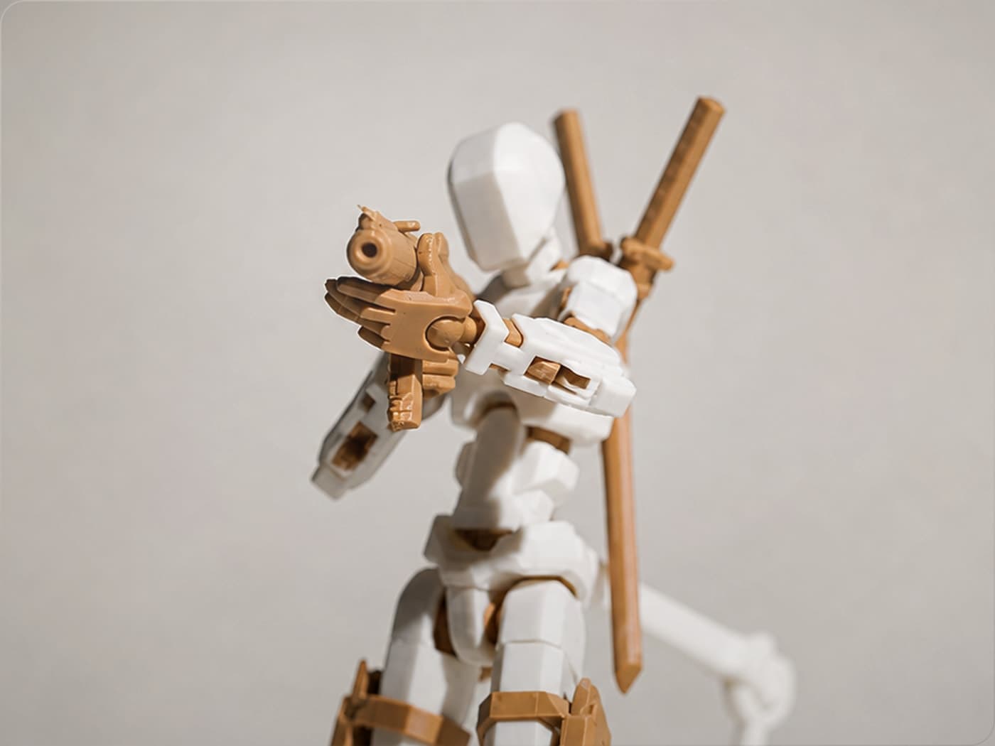 Blue and white Dummy 13 figure holding a translucent blue blaster